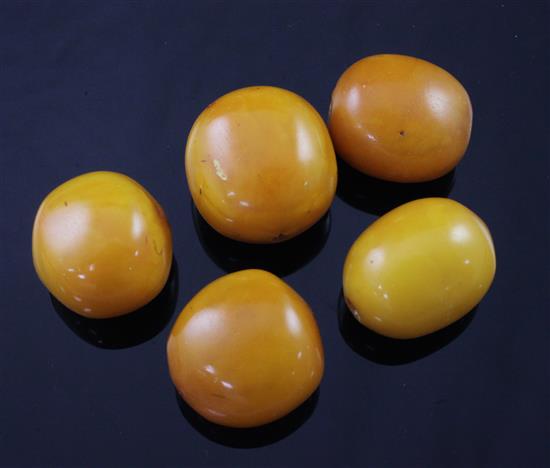 Five loose ovoid amber beads,